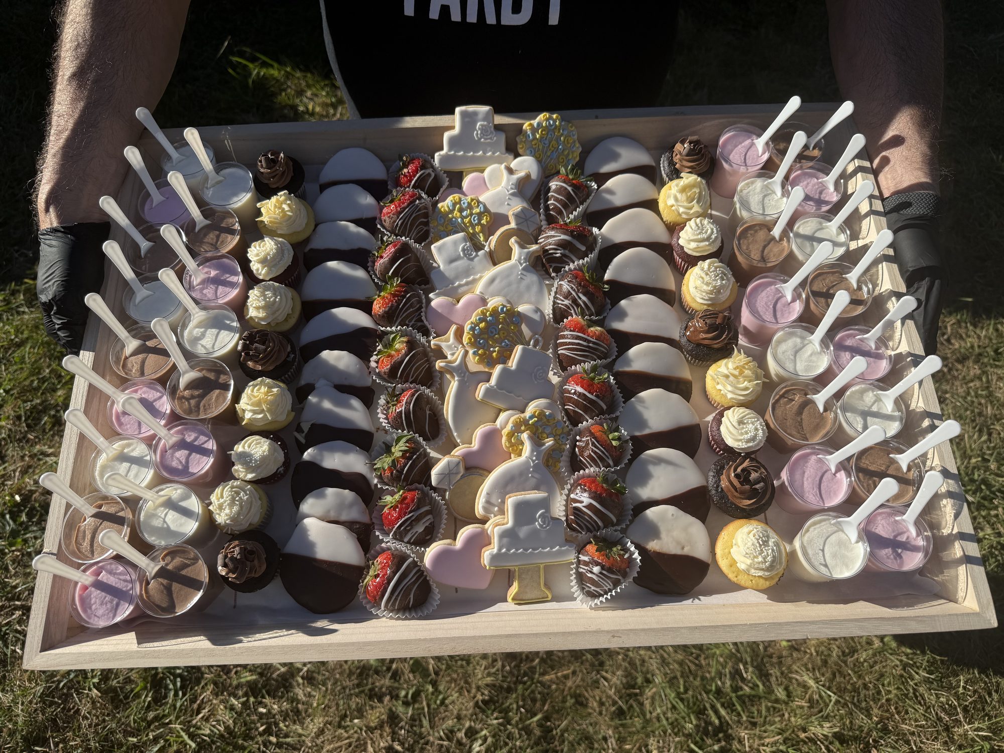 Wedding dessert tray with cookies, cupcakes and chocolate strawberries